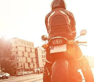 motorcycle rider on motorcycle stopped at stoplight