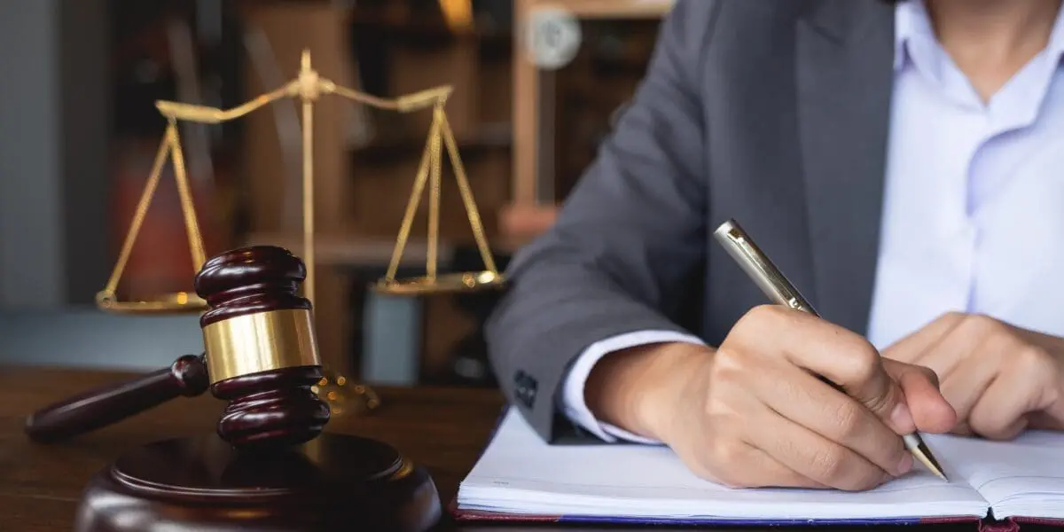 best personal injury attorney orlando signing paperwork at desk