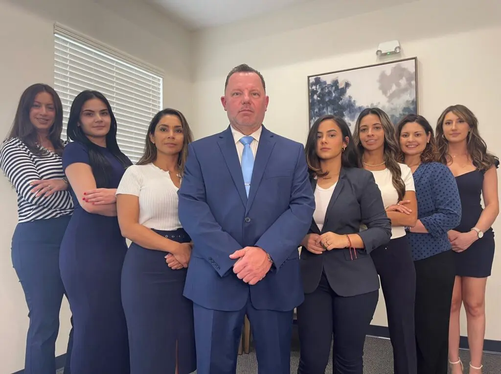 Martindale Law Group Team Photo in navy blue suits and white accents