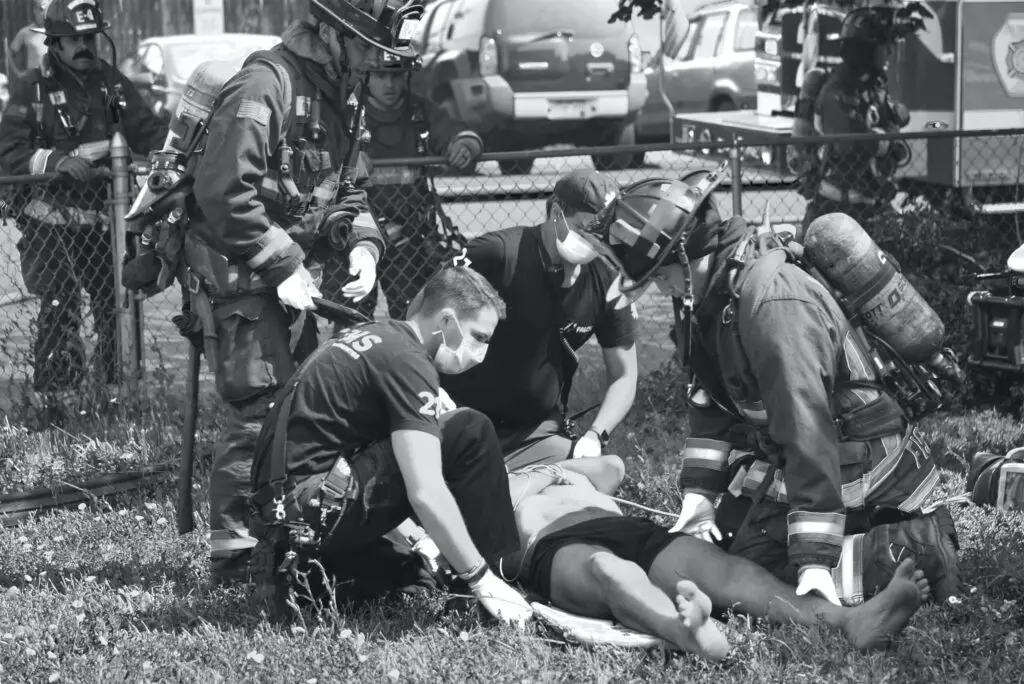 first responders helping accident victim at the scene of an accident
