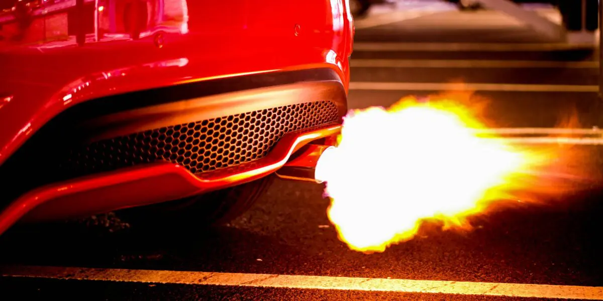 red car with backfiring tailpipe