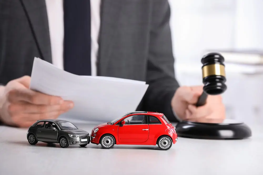 Man reviewing auto accident law documents with a gavel on the table
