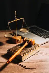 Business lawyers reviewing contract papers with a brass scale on the table