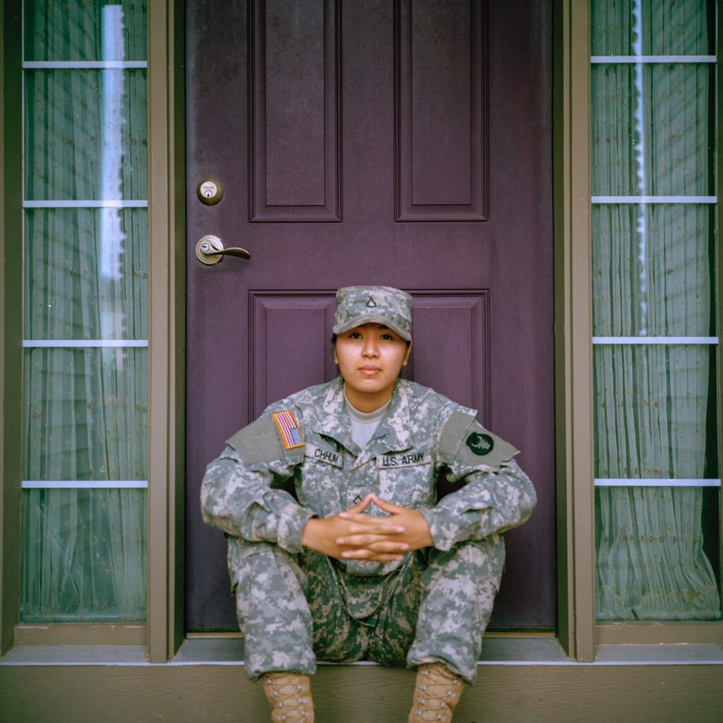 military servicewoman sitting on doorstep