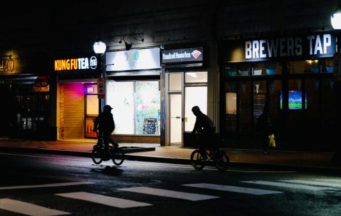 pedestrians crossing a crosswalk at night
