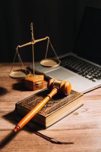 Business lawyers reviewing contract papers with a brass scale on the table